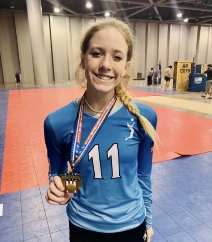 Grace McAlister, 12, poses with volleyball medal from a club volleyball tournament in Mobile, AL.